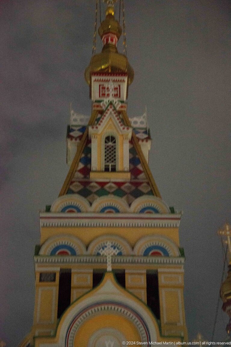 Upper bell-tower detail with multicolored trim at the colorful wooden Zenkov Cathedral in Almaty.