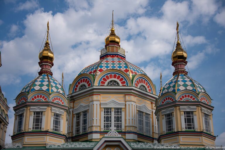 Close daylight view of rear domes at the colorful wooden Zenkov Cathedral in Almaty.