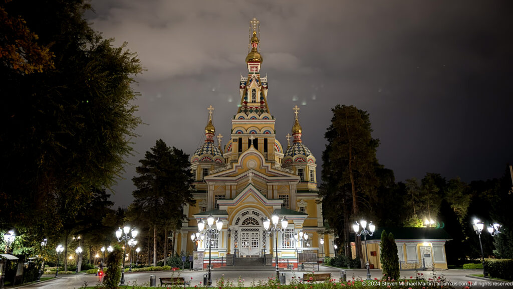 Night frontal approach through park inside Zenkov Cathedral, with Orthodox religious decoration.