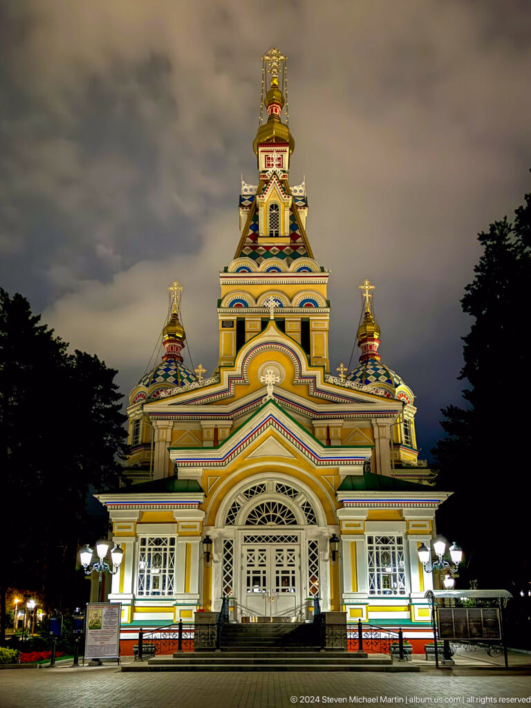 Night close facade and central tower at the colorful wooden Zenkov Cathedral in Almaty.