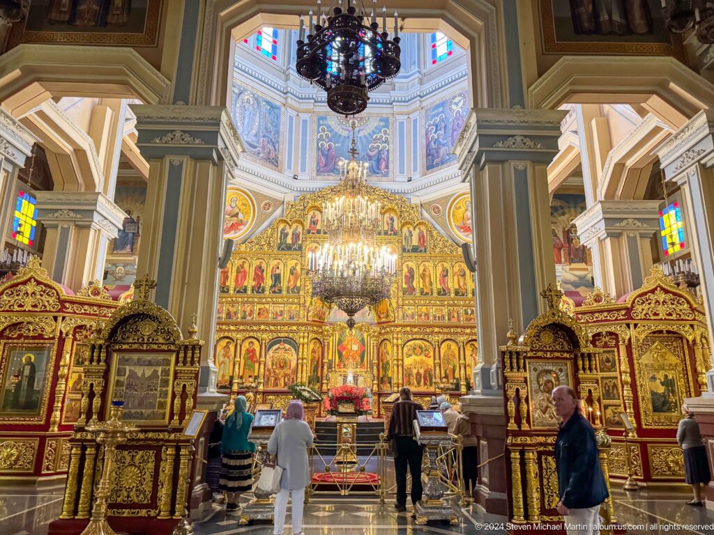 Wide nave toward iconostasis inside Zenkov Cathedral, with Orthodox religious decoration.