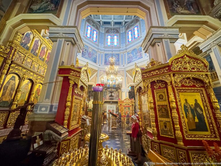 Nave view with icons and chandelier inside Zenkov Cathedral, with Orthodox religious decoration.