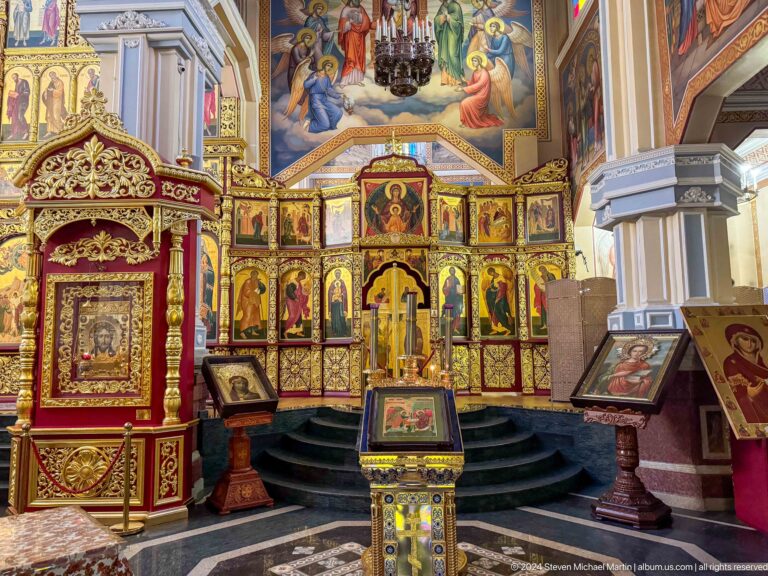 Iconostasis and sanctuary steps inside Zenkov Cathedral, with Orthodox religious decoration.