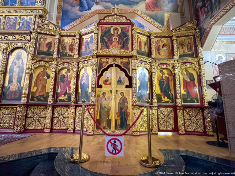 Iconostasis with central royal doors inside Zenkov Cathedral, with Orthodox religious decoration.