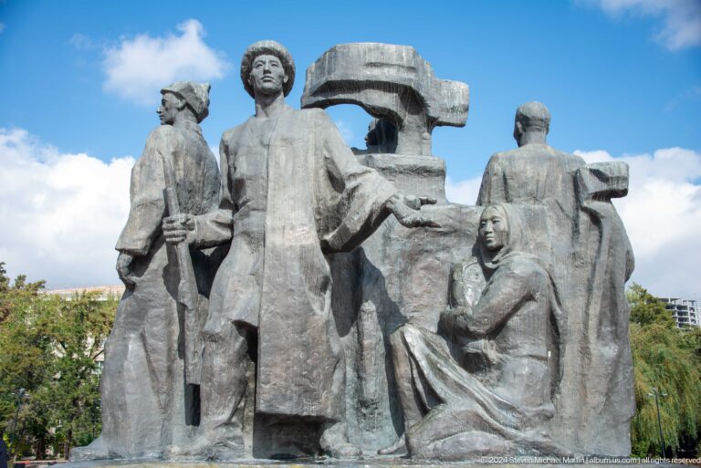 Large stone group of workers and families in Bishkek, Kyrgyzstan.