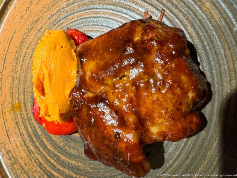 Grilled meat with orange puree on plate in Bishkek, Kyrgyzstan.