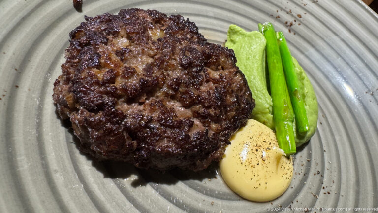 Grilled patty with peppers and sauce in Bishkek, Kyrgyzstan.