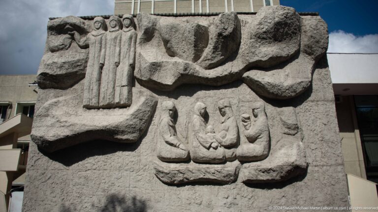 Stone relief of stylized figures and symbols in Bishkek, Kyrgyzstan.