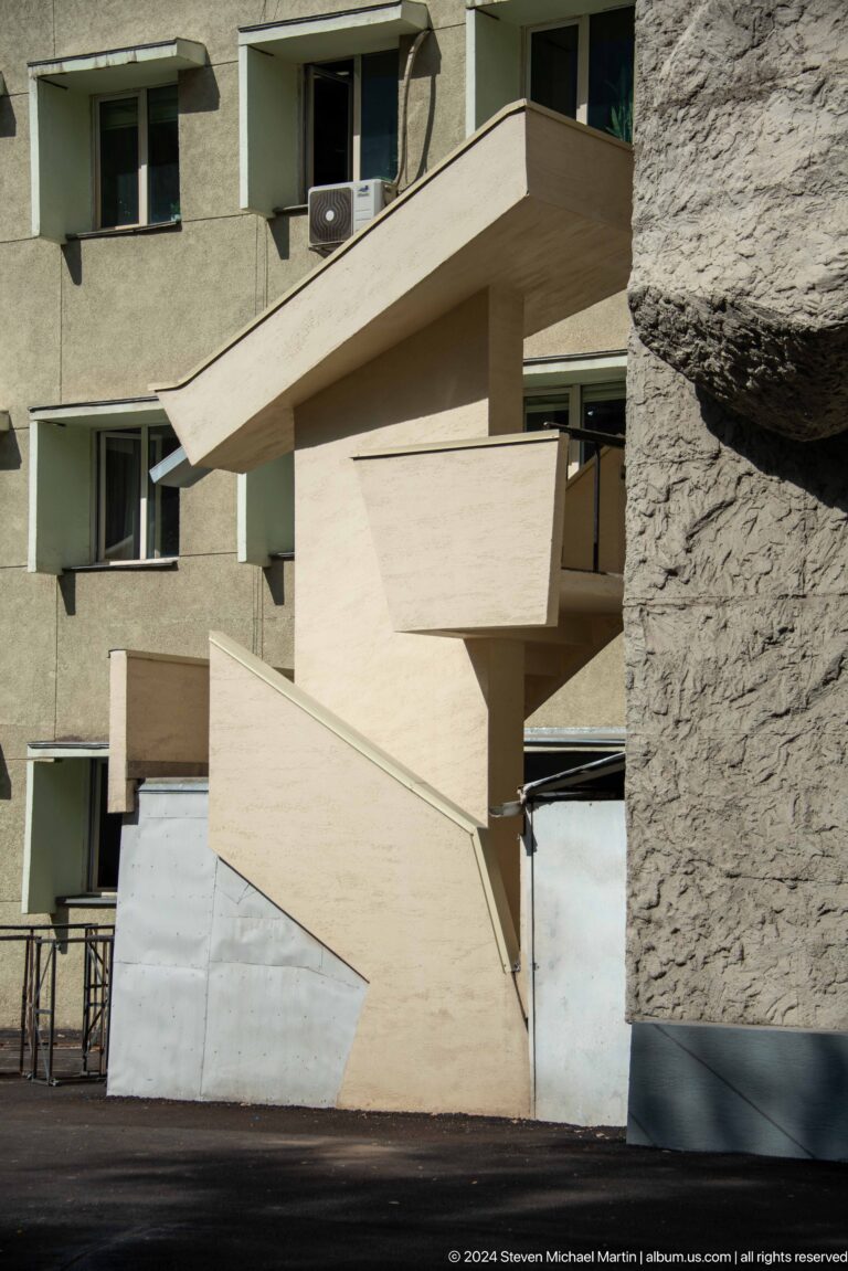 Angular concrete facade and protruding balconies in Bishkek, Kyrgyzstan.