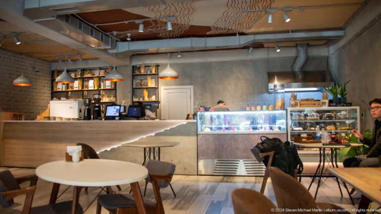 Modern cafe interior with counter and display case in Bishkek, Kyrgyzstan.