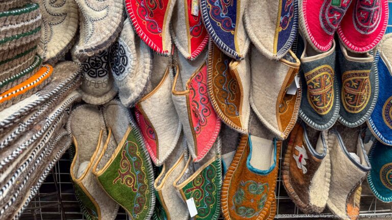 Colorful embroidered slippers hanging in rows in Bishkek, Kyrgyzstan.