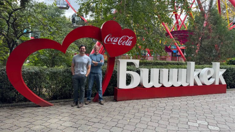 Two visitors standing by Bishkek city sign in Bishkek, Kyrgyzstan.