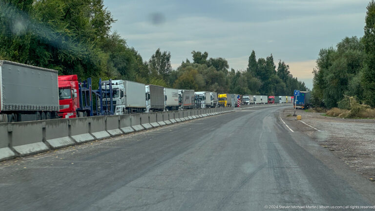 Trucks queued along divided highway in Bishkek, Kyrgyzstan.