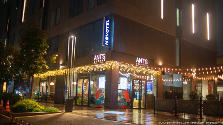 Illuminated ANTS cafe exterior at night in Bishkek, Kyrgyzstan.