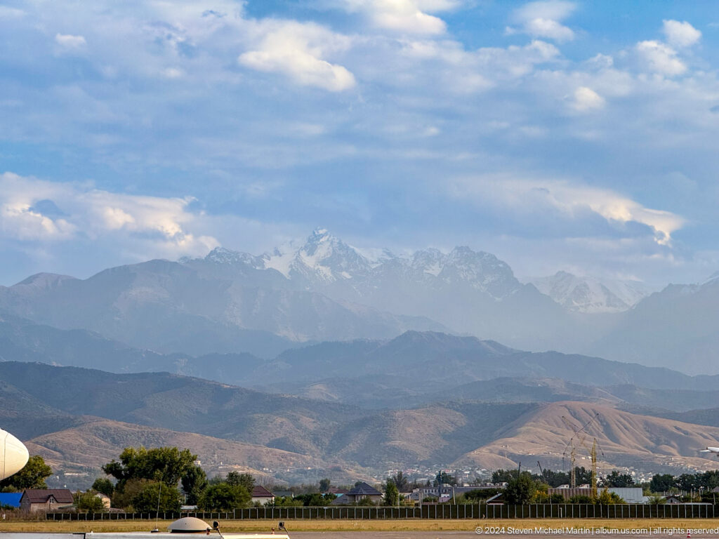 Layered mountain ridges beneath clouds in Bishkek, Kyrgyzstan.