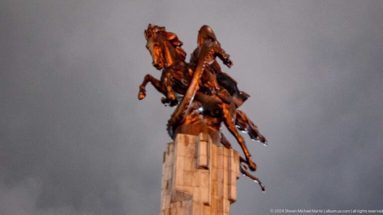 Equestrian statue on tall stone pedestal in Bishkek, Kyrgyzstan.