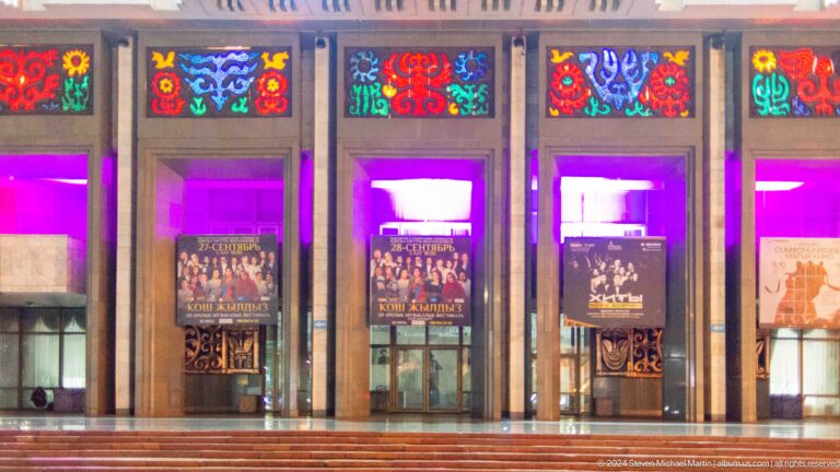Brightly illuminated entrance doors with ornament in Bishkek, Kyrgyzstan.