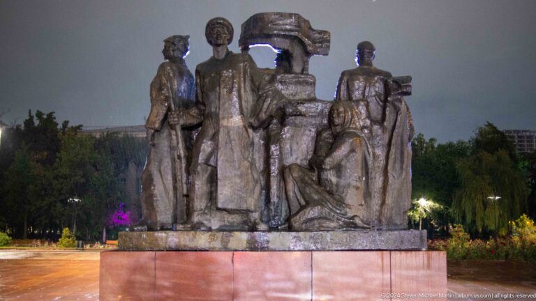 Bronze figures grouped around central pedestal in Bishkek, Kyrgyzstan.