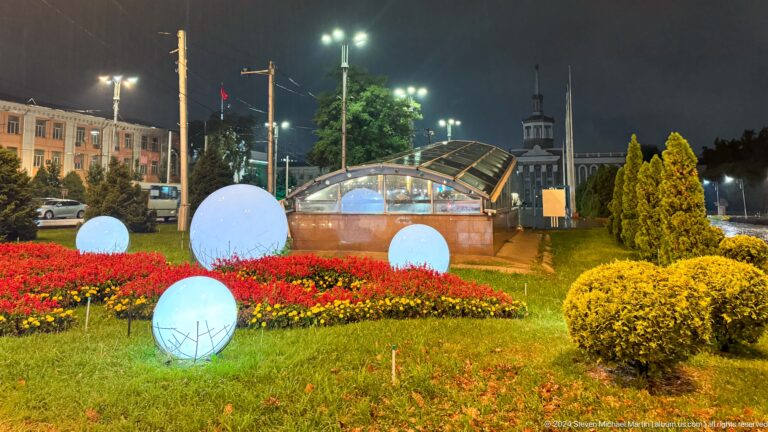 Glowing spheres among flowers at night in Bishkek, Kyrgyzstan.