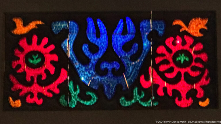 Felt panel with blue central birdlike motif in Bishkek, Kyrgyzstan.