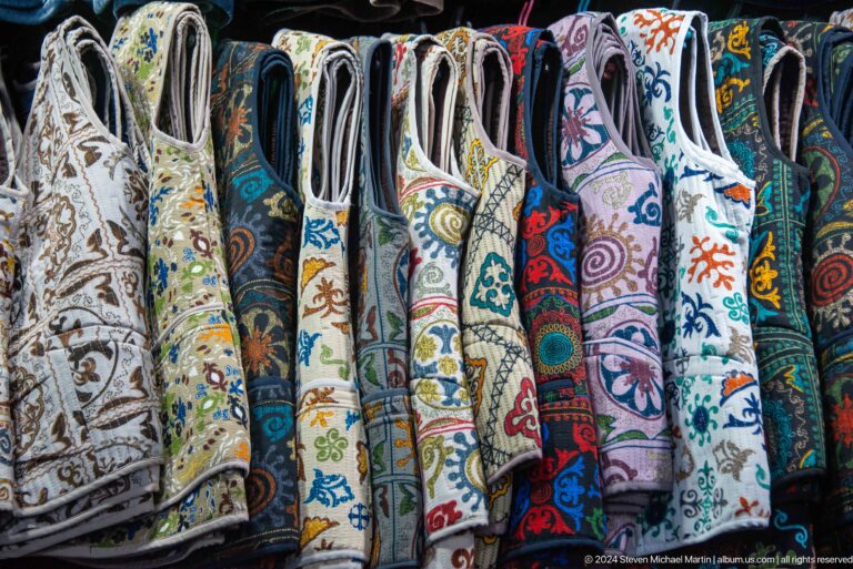 Embroidered robes hanging in market stall in Bishkek, Kyrgyzstan.