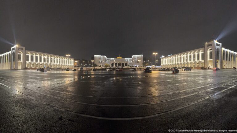 Symmetrical night view across open square in Bishkek, Kyrgyzstan.
