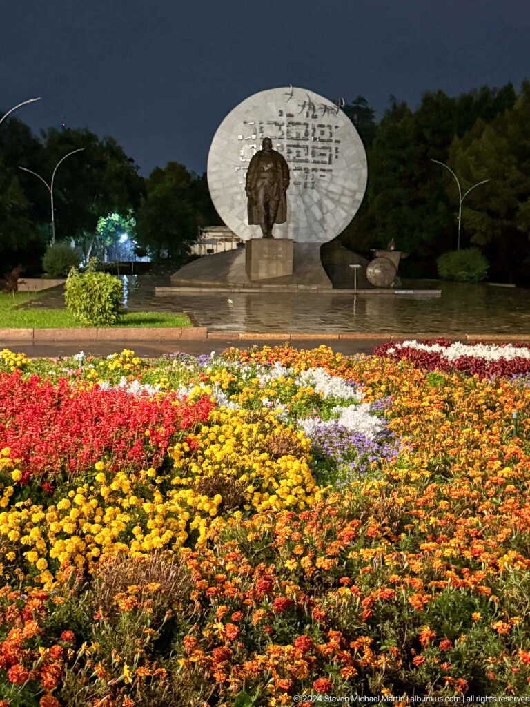 Flower beds before circular memorial in Bishkek, Kyrgyzstan.