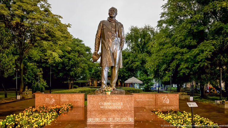 Standing bronze statue in landscaped park in Bishkek, Kyrgyzstan.