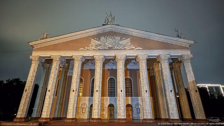 Neoclassical theater facade with tall columns in Bishkek, Kyrgyzstan.