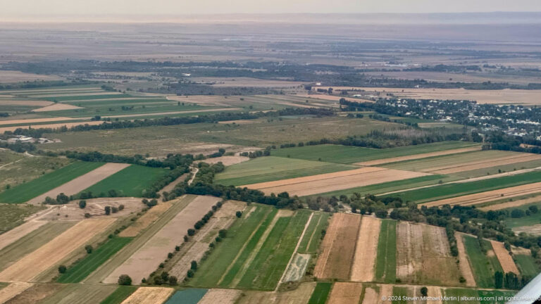 Rectangular farm fields seen from the air in Bishkek, Kyrgyzstan.
