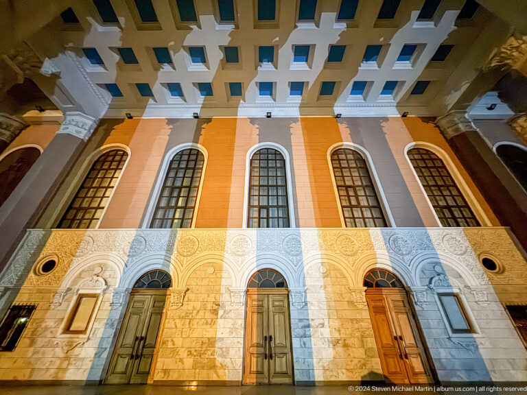 Low-angle view of theater windows and ornament in Bishkek, Kyrgyzstan.
