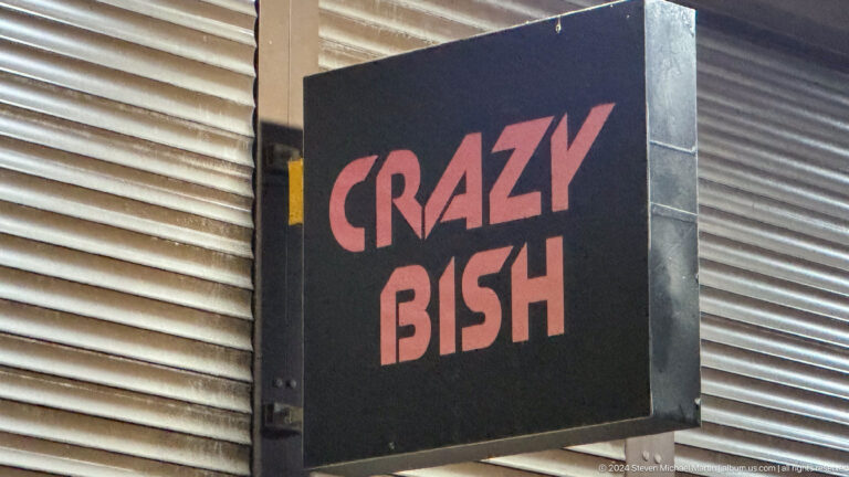 Black sign reading I CRAZY BISH in Bishkek, Kyrgyzstan.