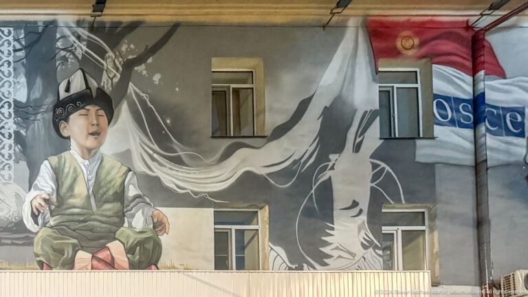 Large mural of man with white flowing fabric in Bishkek, Kyrgyzstan.