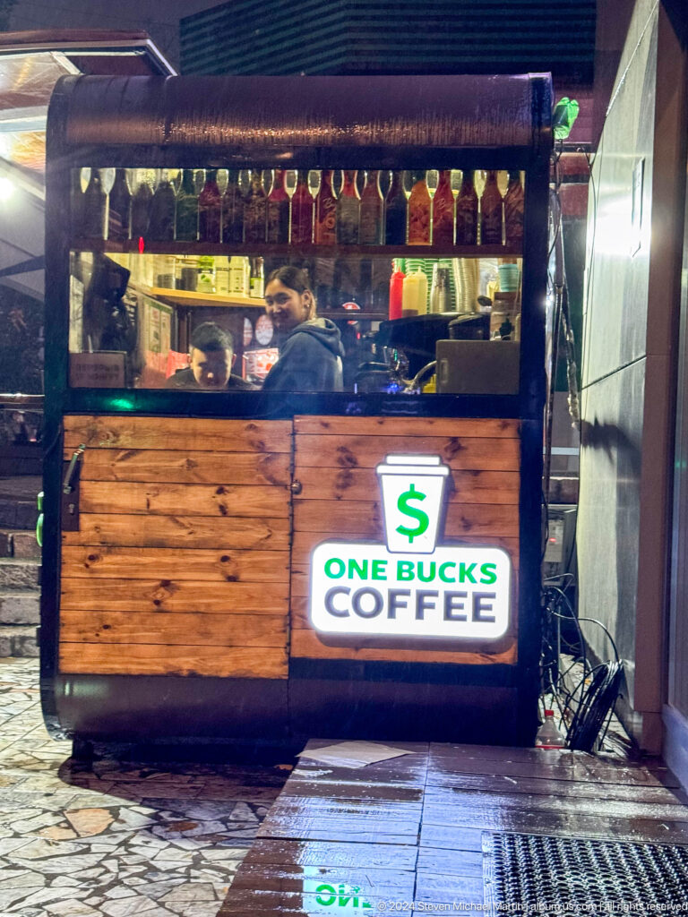 Small coffee kiosk with ON BUCKS sign in Bishkek, Kyrgyzstan.