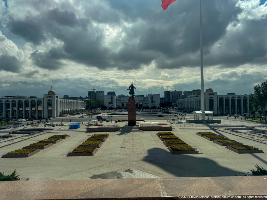 View across fountains and open square toward civic buildings.