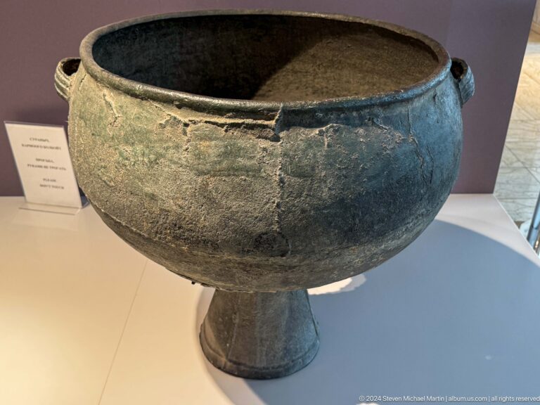 Large bronze cauldron on a pedestal foot.