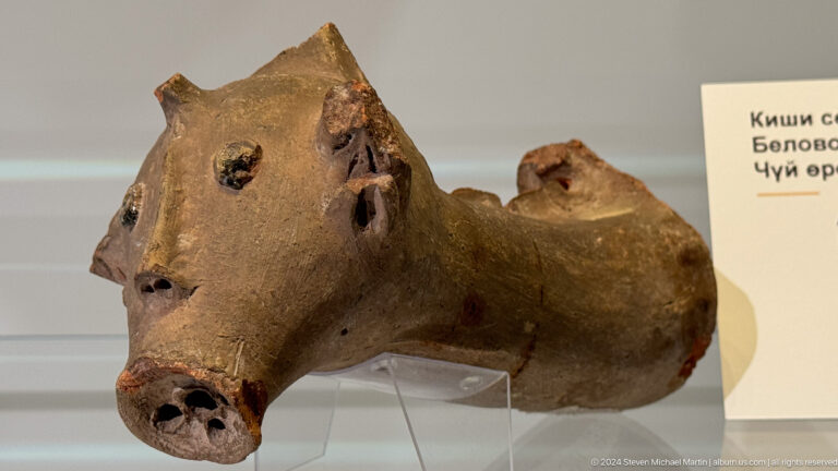 Brown ceramic object modeled as a reclining animal.