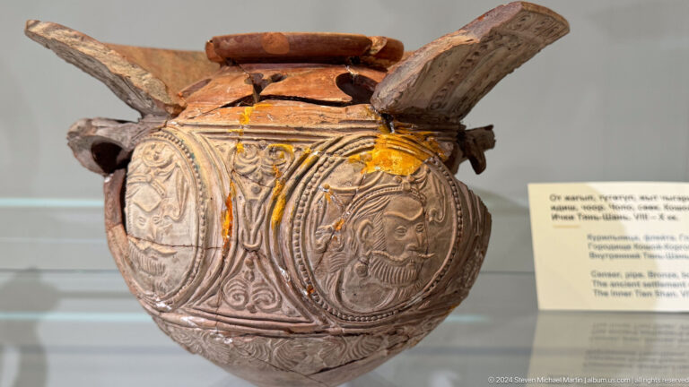 Ornamented ceramic bowl with handle-like projection.