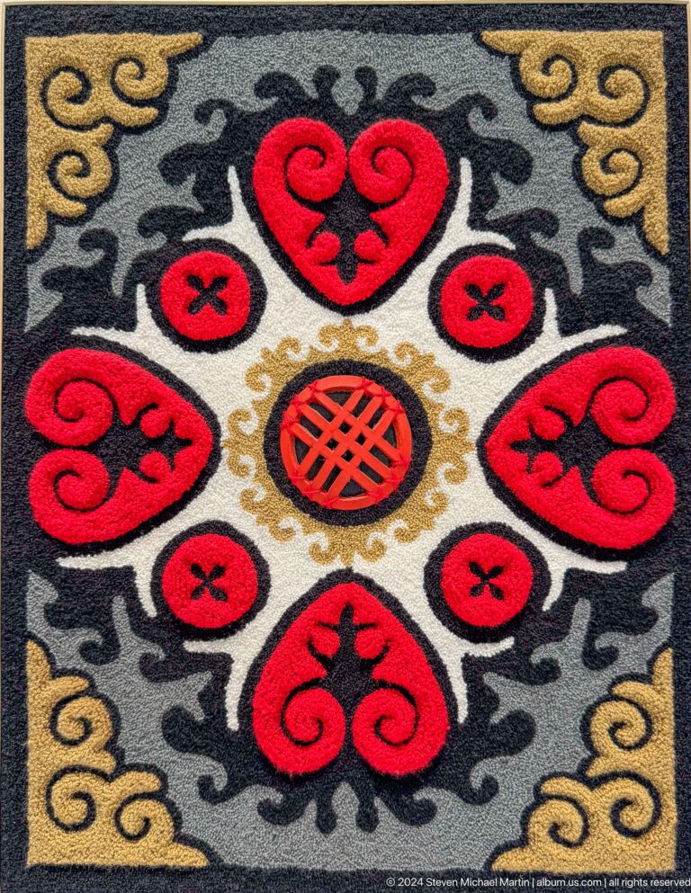 Close view of red black and cream felt ornament.