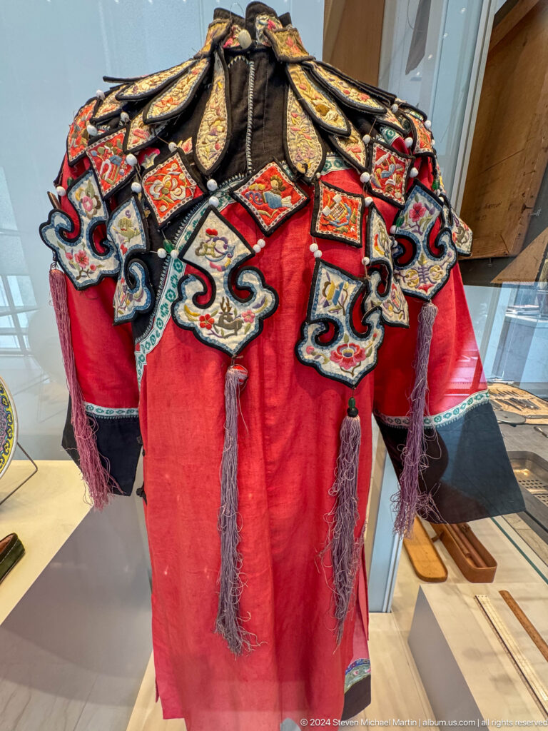 Close view of richly embroidered red coat.