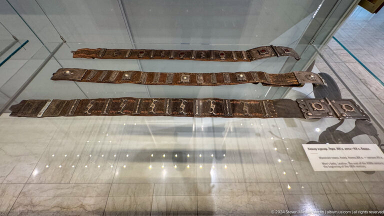 Long narrow wooden objects displayed horizontally.