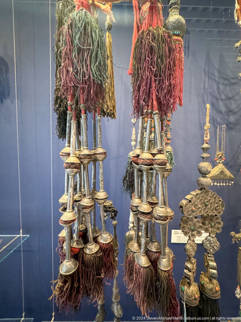 Hanging silver ornaments with long tassels.