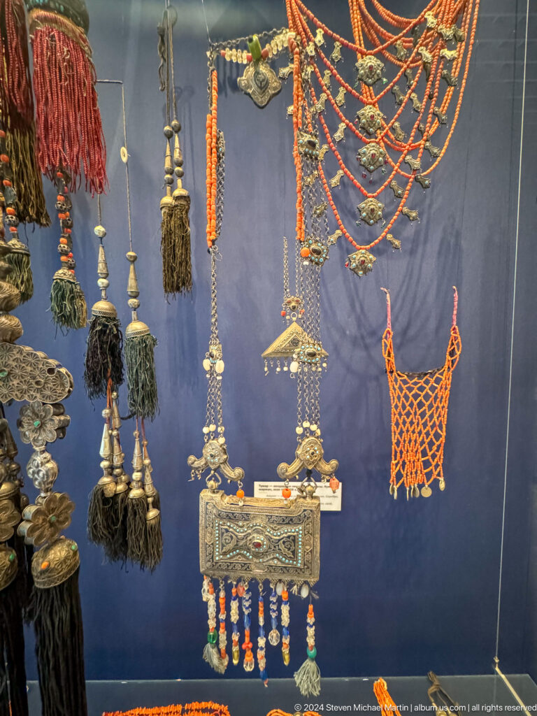 Assortment of silver pendants and tasselled ornaments.