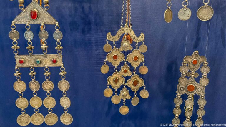 Elaborate silver pectorals formed from chains and disks.