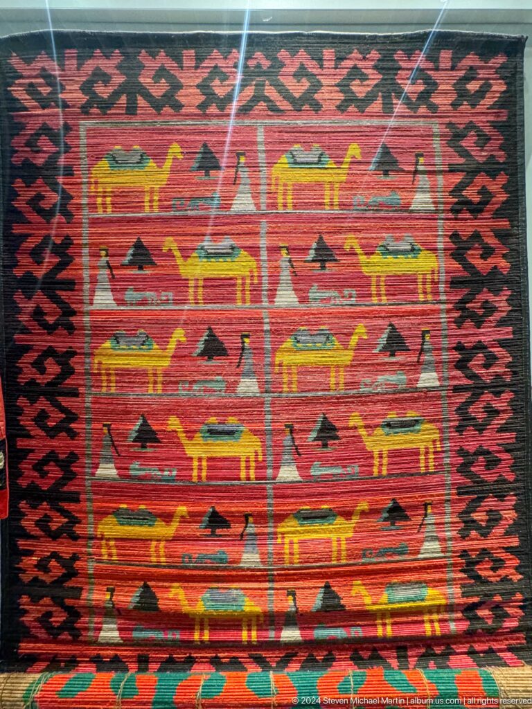 Woven textile with rows of stylized animals.