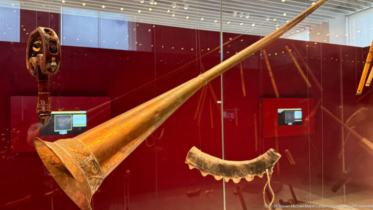 Long-necked wooden lute displayed diagonally.