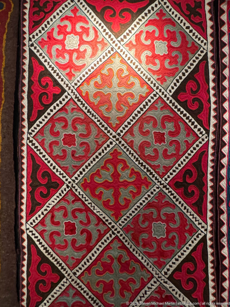 Red white and gray felt carpet with diamond lattice.