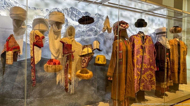 Mannequins in layered robes and tall hats.