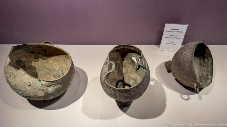 Three prehistoric ceramic vessels in a display case.