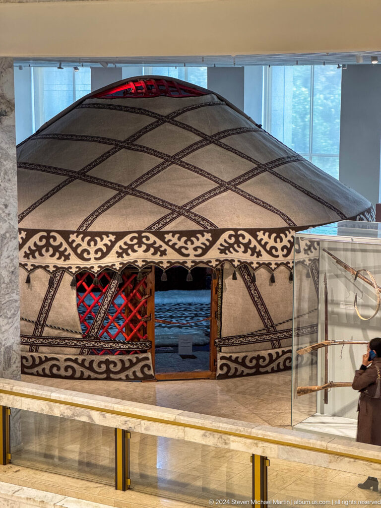 Reconstructed yurt exterior with patterned felt doorway.